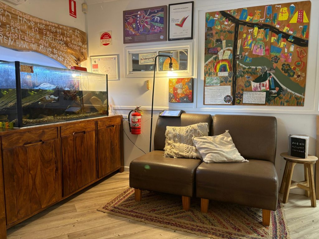 Cozy waiting area with a fish tank and art.