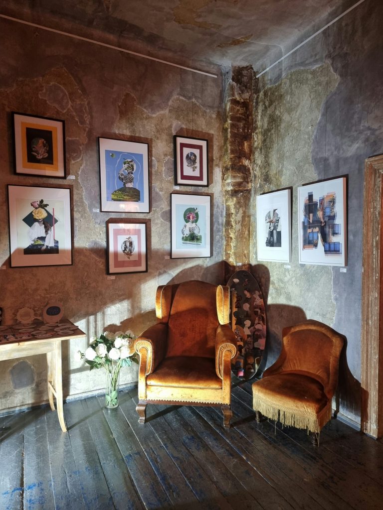 a living room filled with furniture and pictures on the wall